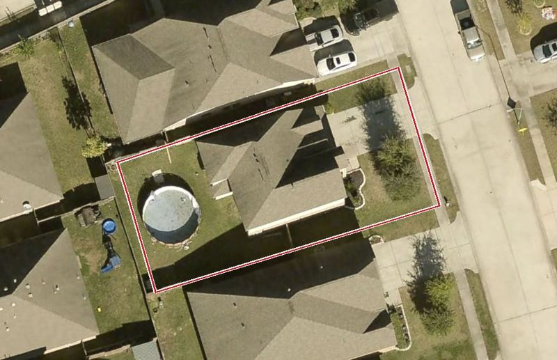 Aerial photo of 13711 Kodiak Brown Bear St, lot outlined in red